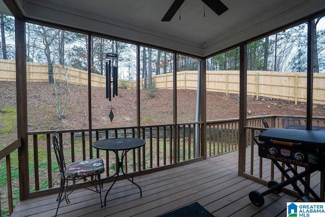 sunroom / solarium featuring ceiling fan