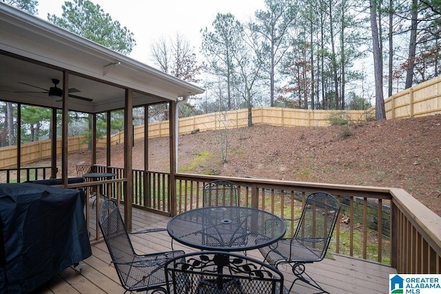 wooden terrace featuring area for grilling and ceiling fan