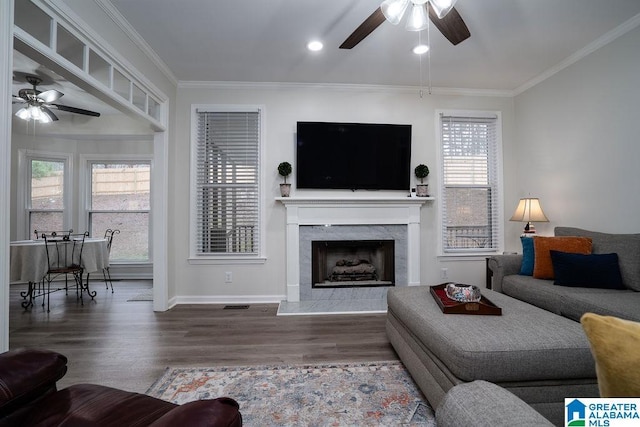 living room with hardwood / wood-style flooring, plenty of natural light, and ornamental molding