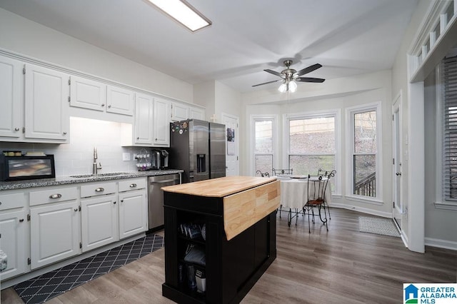 kitchen with white cabinetry, appliances with stainless steel finishes, and sink