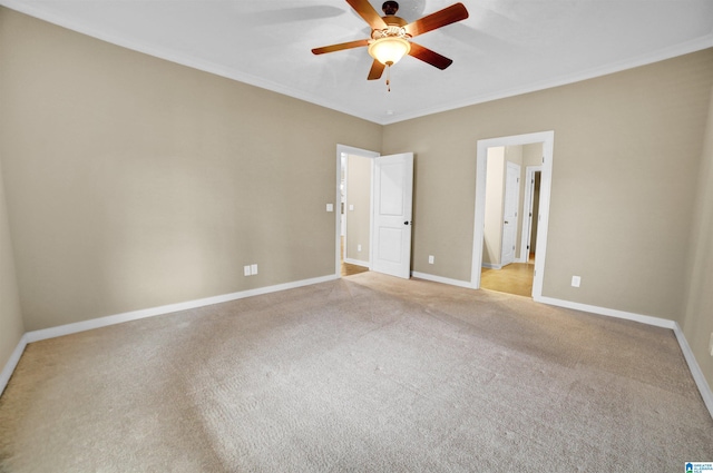 unfurnished bedroom featuring crown molding, light carpet, and ceiling fan