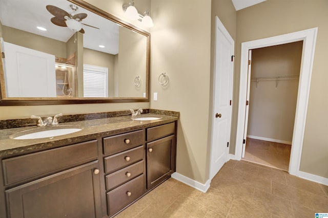 bathroom featuring ceiling fan, vanity, an enclosed shower, and tile patterned flooring