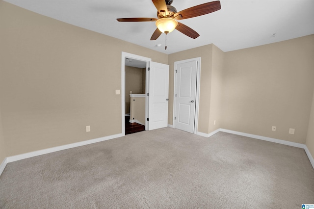 unfurnished bedroom featuring ceiling fan and light carpet