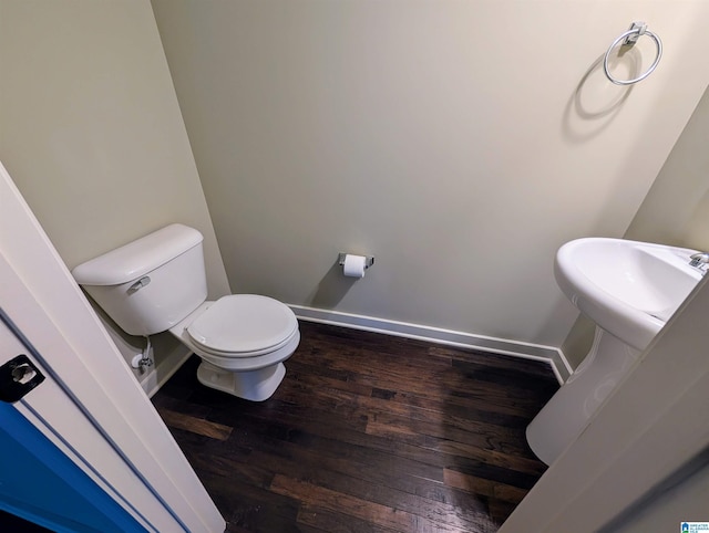 bathroom featuring wood-type flooring and toilet