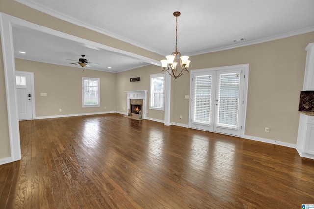 unfurnished living room with crown molding, a fireplace, dark hardwood / wood-style flooring, and ceiling fan with notable chandelier