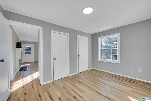 unfurnished bedroom with crown molding and light hardwood / wood-style floors