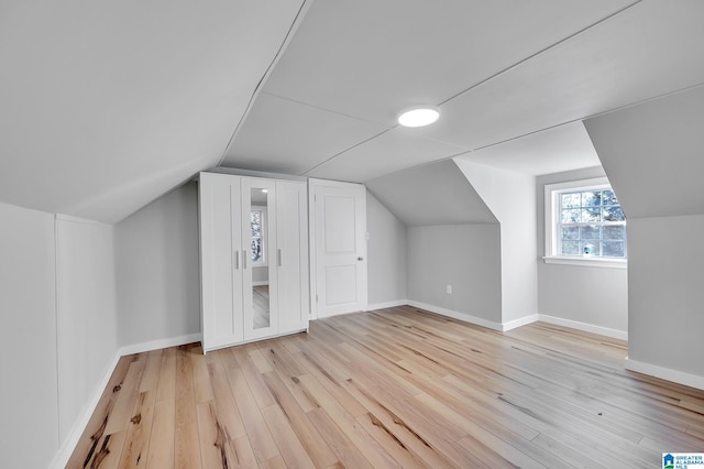 bonus room featuring lofted ceiling and light hardwood / wood-style floors