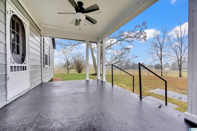 view of patio featuring ceiling fan and a rural view