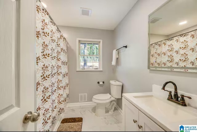 bathroom featuring vanity and toilet