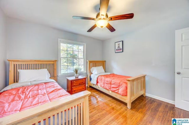 bedroom with hardwood / wood-style floors and ceiling fan