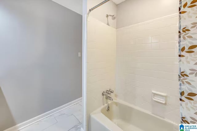 bathroom with shower / bath combo with shower curtain