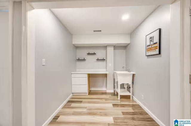 bar with light hardwood / wood-style flooring