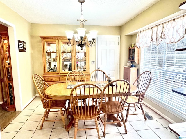 dining room with a notable chandelier and light tile patterned flooring