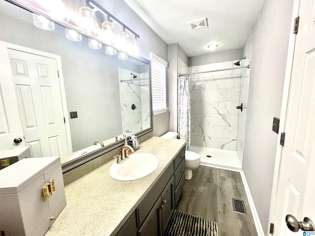 bathroom featuring a shower with curtain, wood-type flooring, toilet, and vanity