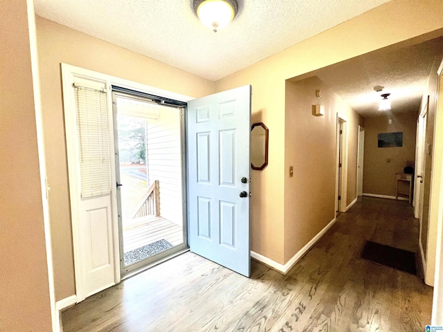 foyer featuring hardwood / wood-style flooring and a textured ceiling