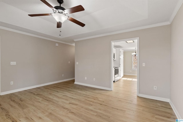 spare room with ceiling fan with notable chandelier, ornamental molding, a raised ceiling, and light hardwood / wood-style floors