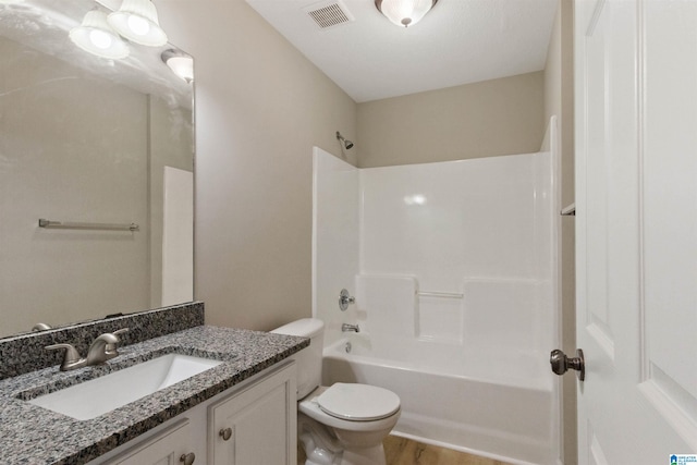 full bathroom featuring wood-type flooring, tub / shower combination, vanity, and toilet