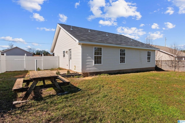 back of property featuring a yard