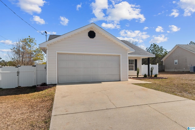 view of front of property featuring a garage and central AC unit