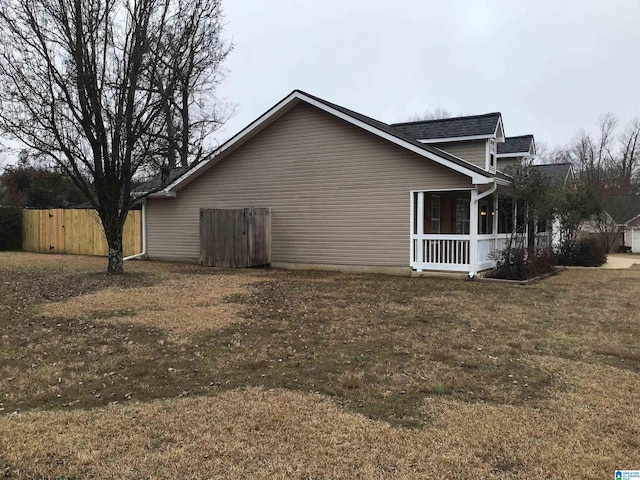 view of side of property with a lawn