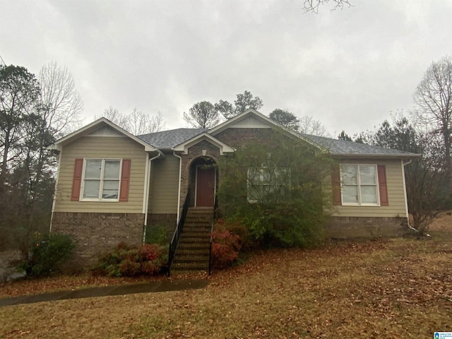 single story home featuring brick siding