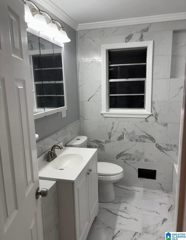 bathroom with vanity, crown molding, tile walls, and toilet