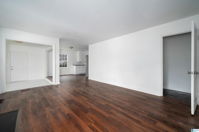 unfurnished living room featuring dark wood-type flooring