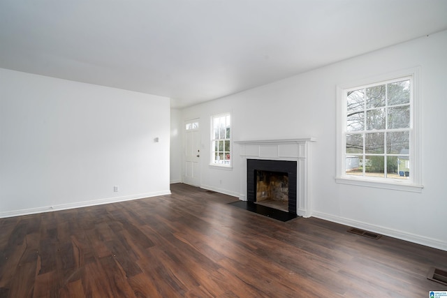 unfurnished living room featuring dark hardwood / wood-style flooring