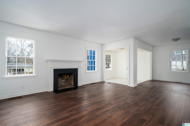 unfurnished living room featuring dark hardwood / wood-style flooring