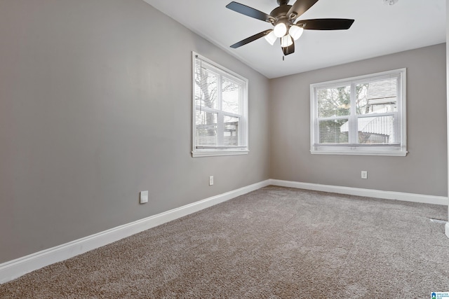 carpeted empty room featuring ceiling fan