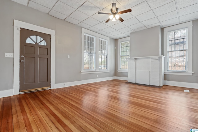 entryway featuring ceiling fan, light wood-type flooring, and a drop ceiling