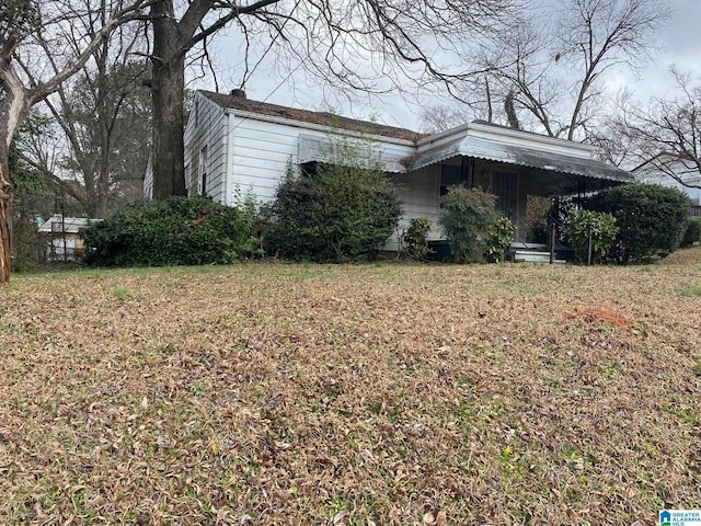 view of side of home featuring a lawn