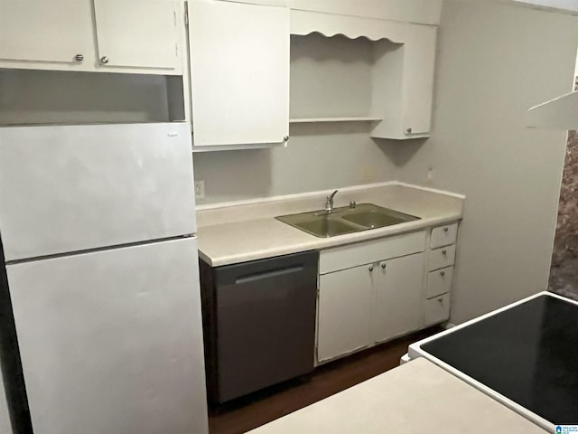 kitchen featuring white cabinets, sink, dishwashing machine, and refrigerator