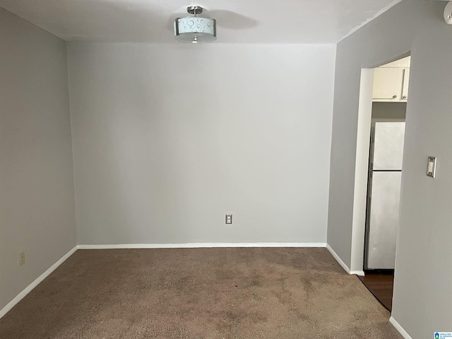 empty room with dark carpet