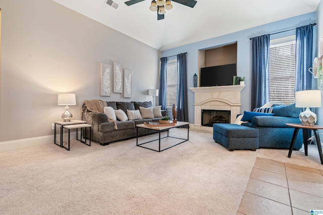 carpeted living room featuring vaulted ceiling and ceiling fan