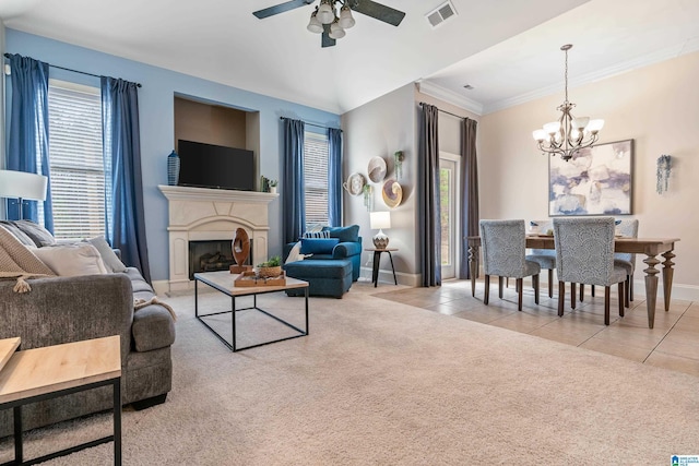 carpeted living room with crown molding and ceiling fan with notable chandelier