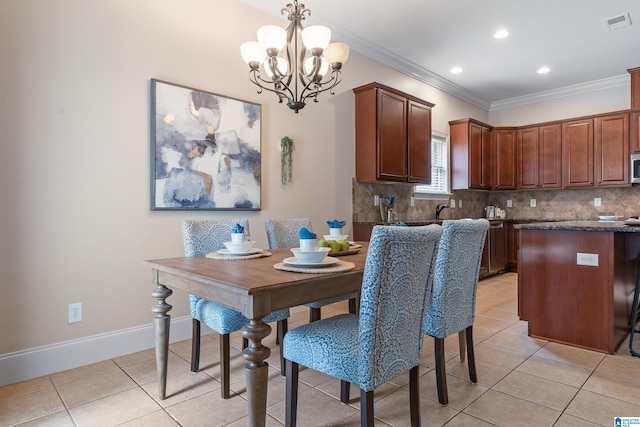 tiled dining space with crown molding, sink, and a notable chandelier