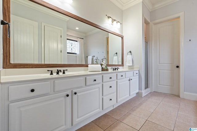 bathroom with tile patterned flooring, ornamental molding, and vanity