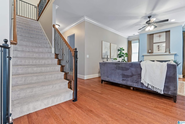 interior space featuring hardwood / wood-style flooring, ornamental molding, and ceiling fan