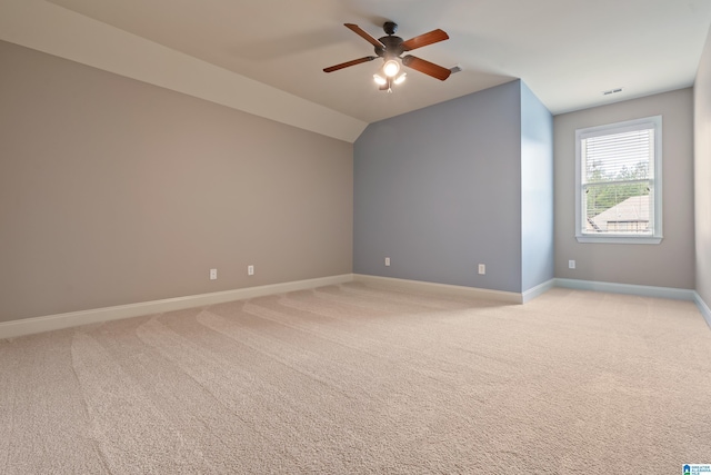 unfurnished room with ceiling fan, vaulted ceiling, and light carpet