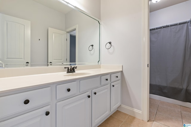 bathroom featuring tile patterned flooring, vanity, and a shower with shower curtain