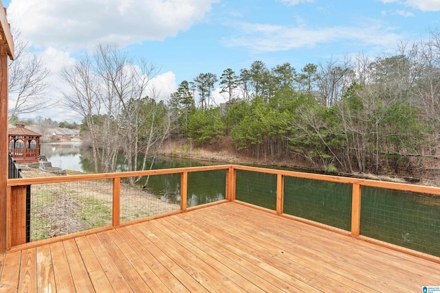 wooden terrace featuring a water view and a gazebo