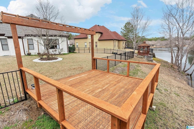 deck featuring a yard, a gazebo, and a water view