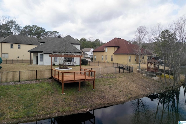 view of yard with a deck with water view and a pergola