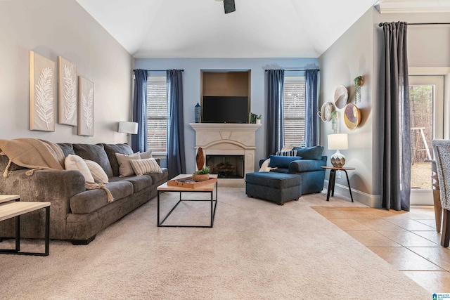 tiled living room featuring plenty of natural light and lofted ceiling