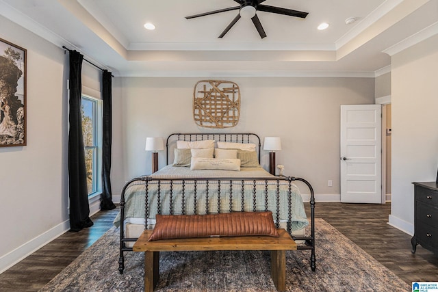 bedroom featuring baseboards, a raised ceiling, and dark wood-style flooring