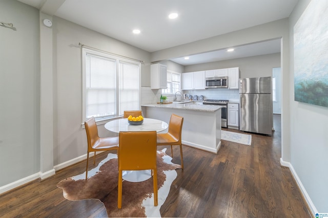 dining room featuring dark hardwood / wood-style flooring and sink