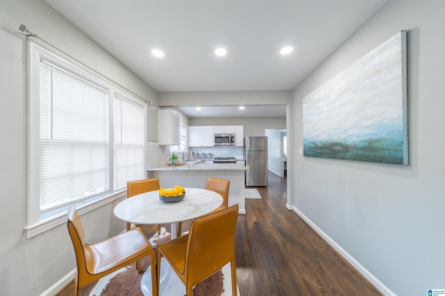 dining area with dark hardwood / wood-style flooring