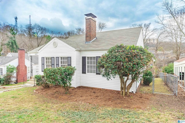 view of side of home featuring a lawn