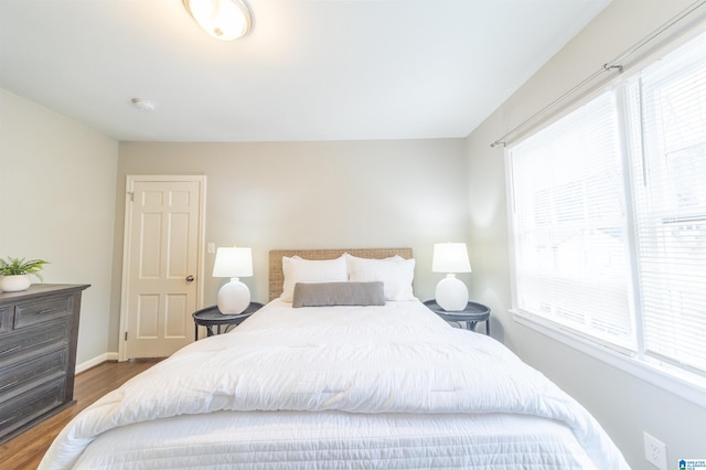 bedroom with dark hardwood / wood-style flooring